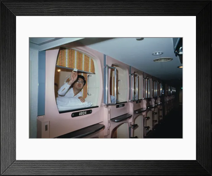 Framed Print : Capsule Hotel Guest Closing His Room Door Framed Print : Capsule Hotel Guest Closing His Room Door