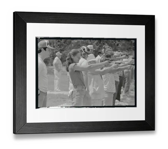 Framed Print : Woman Practicing Firing a Gun Framed Print : Woman Practicing Firing a Gun