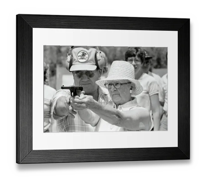 Framed Print : Woman Practicing Firing a Gun Framed Print : Woman Practicing Firing a Gun