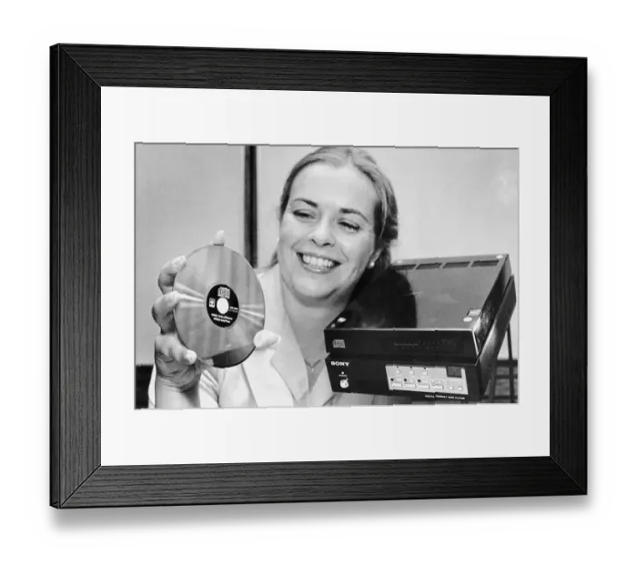 Framed Print : Woman Displaying Compact Disc and Player Framed Print : Woman Displaying Compact Disc and Player