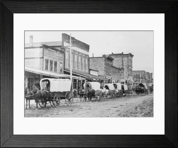 Framed Print : Wagon Train Moving Through Town Framed Print : Wagon Train Moving Through Town