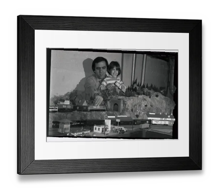 Framed Print : Man and Daughter Running Toy Trains Framed Print : Man and Daughter Running Toy Trains