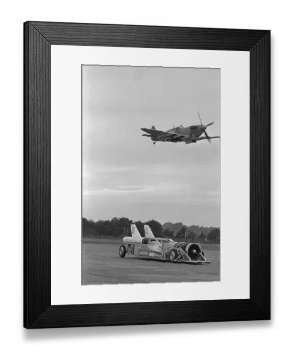Framed Print : Airplane Flying Over Race Car in Action Framed Print : Airplane Flying Over Race Car in Action