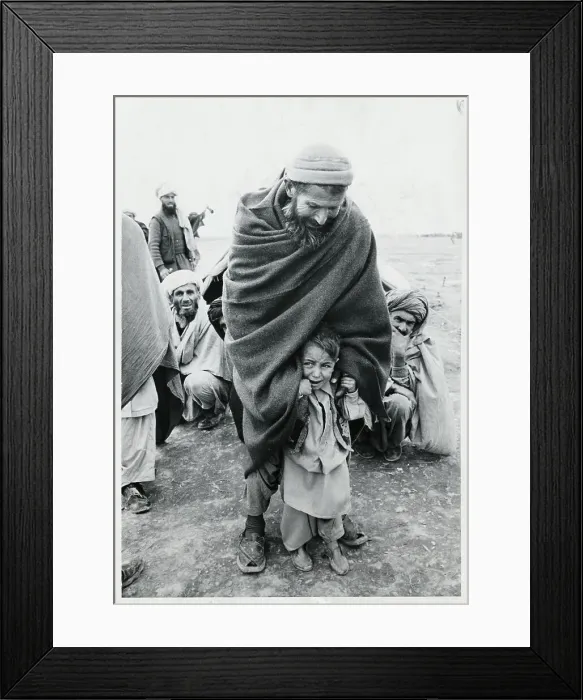 Framed Print : Afghan Man Protecting a Crying Child