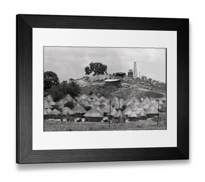 Framed Print : Grass Huts at Base of Hill