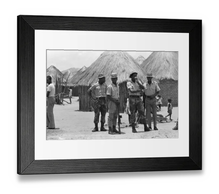 Framed Print : Paramilitary Patrol Beside Huts Framed Print : Paramilitary Patrol Beside Huts