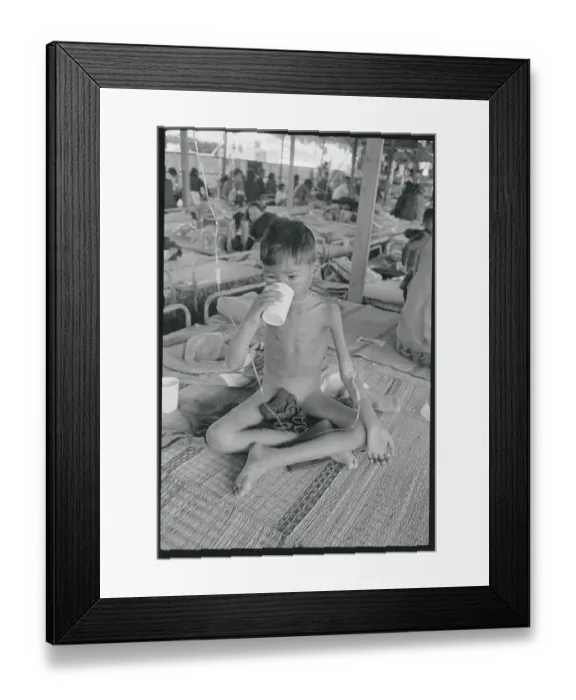 Framed Print : Cambodian Refugee Boy Drinking Medicine Framed Print : Cambodian Refugee Boy Drinking Medicine