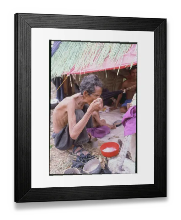 Framed Print : Cambodian Refugee Eating Framed Print : Cambodian Refugee Eating