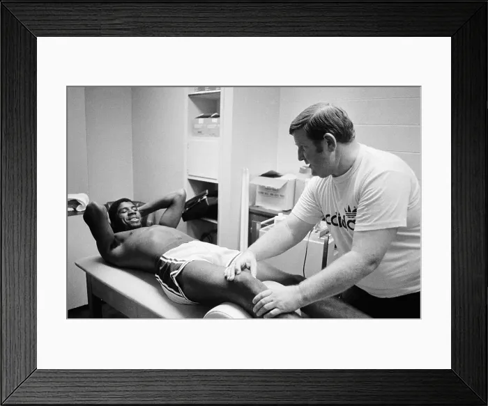 Framed Print : Trainer Working on Magic Johnson's Leg Framed Print : Trainer Working on Magic Johnson's Leg