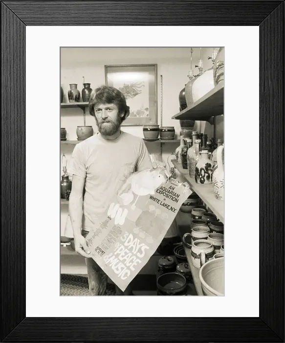 Framed Print : Man Holding Original Woodstock Poster Framed Print : Man Holding Original Woodstock Poster