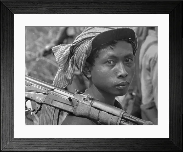 Framed Print : Young Vietnamese Carrying Weapon of War Framed Print : Young Vietnamese Carrying Weapon of War