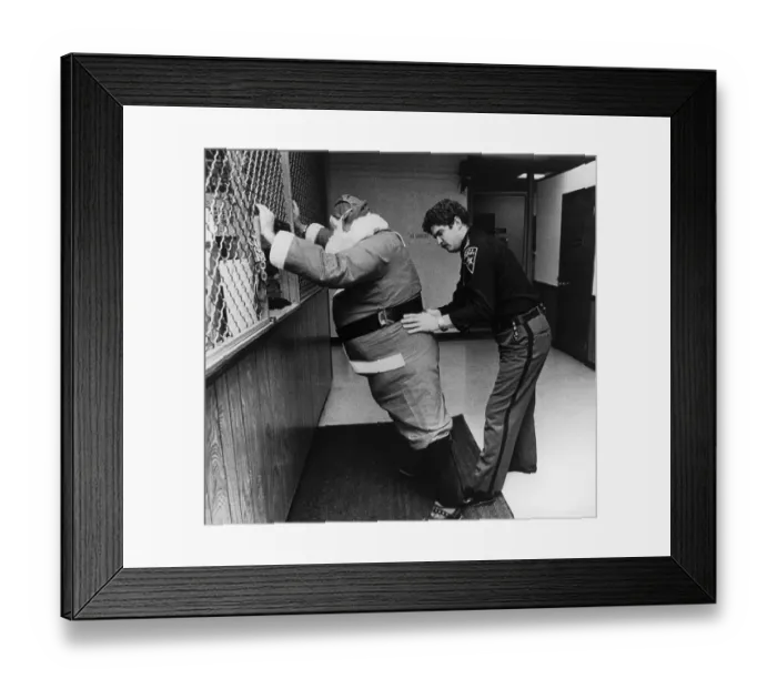 Framed Print : Sheriff Frisking Santa Claus Framed Print : Sheriff Frisking Santa Claus