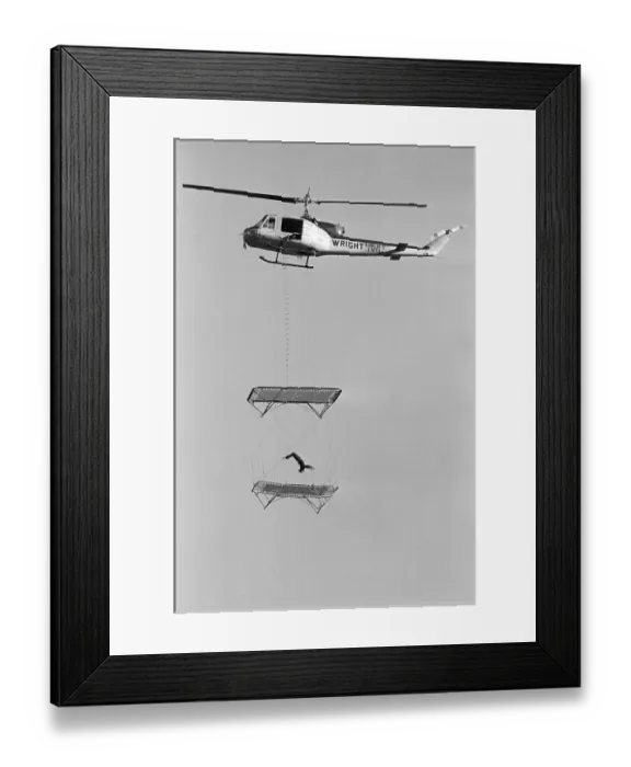 Framed Print : Man Jumps On Trampoline Hanging From Hel Framed Print : Man Jumps On Trampoline Hanging From Hel
