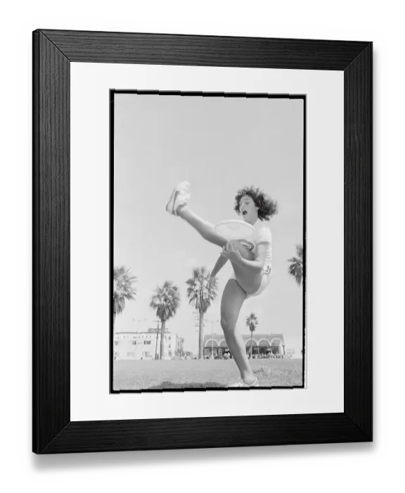Framed Print : Laura Engel Catching Frisbee Through Her Legs Framed Print : Laura Engel Catching Frisbee Through Her Legs