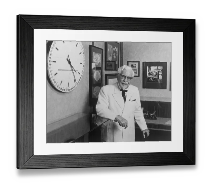 Framed Print : Colonel Harland Sanders Standing by Wall Clock