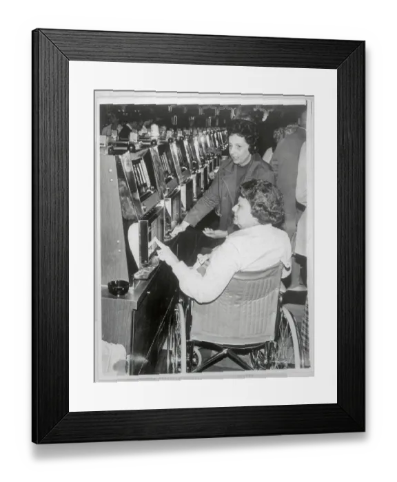 Framed Print : Woman in Wheelchair Playing Slot Machines Framed Print : Woman in Wheelchair Playing Slot Machines