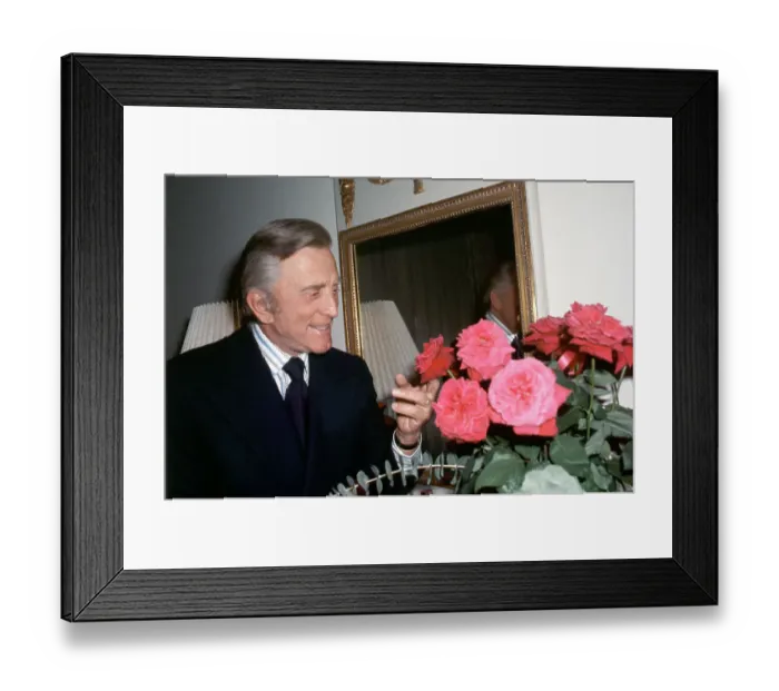 Framed Print : Actor Kirk Douglas Looking At Roses