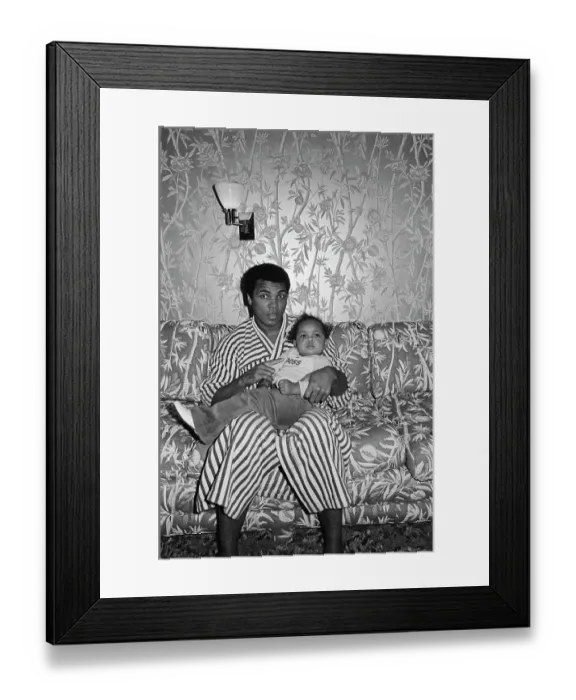 Framed Print : Muhammad Ali Sitting on Couch With Baby Framed Print : Muhammad Ali Sitting on Couch With Baby