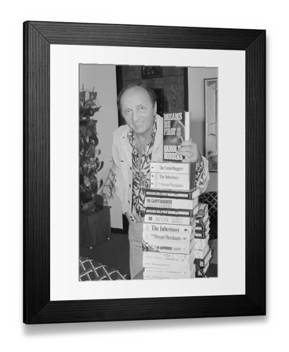 Framed Print : Harold Robbins Holding Stack of Books Framed Print : Harold Robbins Holding Stack of Books