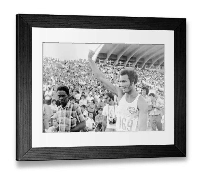 Framed Print : Track Star Alberto Juantoreena Raising His Hand at Ceremonies Framed Print : Track Star Alberto Juantoreena Raising His Hand at Ceremonies