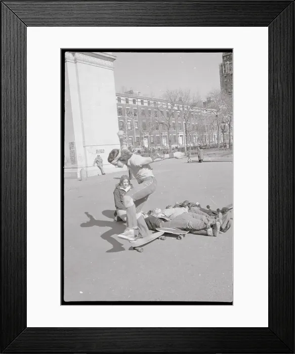 Framed Print : Boy Completing Jump over Bodies onto Skateboard