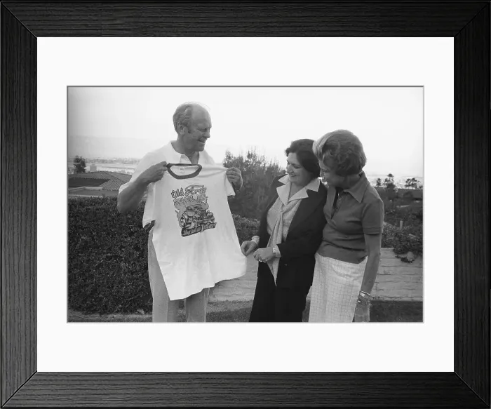 Framed Print : Gerald Ford Holding up Shirt with Wife and Helen Thomas in Observance Framed Print : Gerald Ford Holding up Shirt with Wife and Helen Thomas in Observance