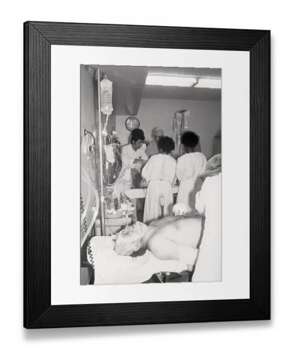 Framed Print : Doctors Examining Plane Crash Survivor Framed Print : Doctors Examining Plane Crash Survivor