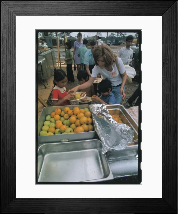 Framed Print : Woman Distributing Food to a Refugee Framed Print : Woman Distributing Food to a Refugee