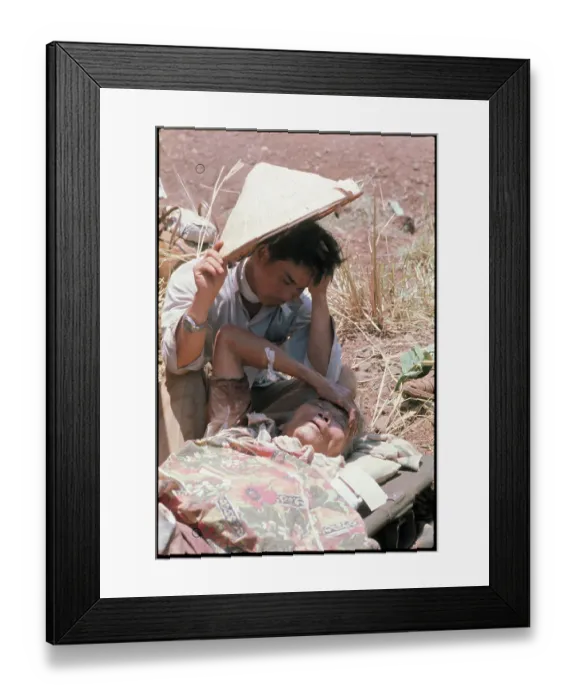 Framed Print : Vietnamese Refugee Shielding Elderly Woman from Sun Framed Print : Vietnamese Refugee Shielding Elderly Woman from Sun