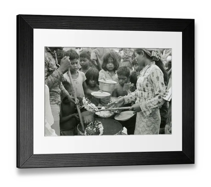 Framed Print : Red Cross Worker Feeding Children Framed Print : Red Cross Worker Feeding Children