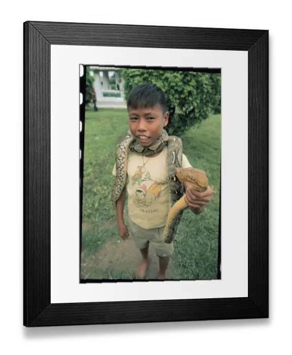 Framed Print : Boy with Snake Around His Neck Framed Print : Boy with Snake Around His Neck