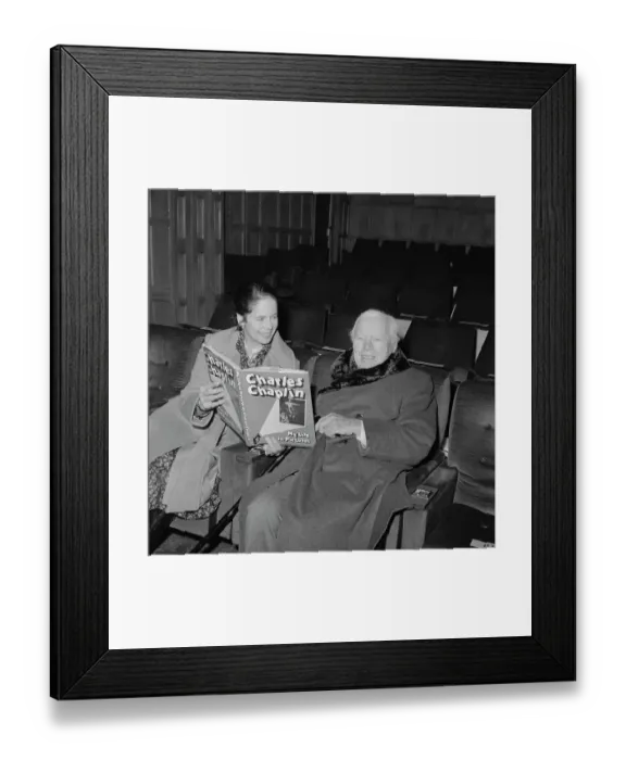 Framed Print : Charlie and Oona Chaplin Looking at a Book Framed Print : Charlie and Oona Chaplin Looking at a Book