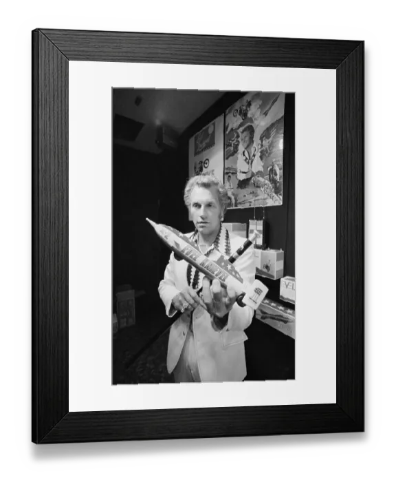 Framed Print : Evel Knievel Displaying a Model Framed Print : Evel Knievel Displaying a Model