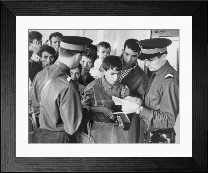 Framed Print : Immigration Officers Reviewing a Person's Papers Framed Print : Immigration Officers Reviewing a Person's Papers
