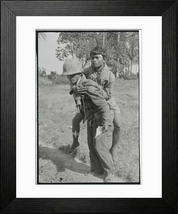Framed Print : Soldier Carrying Injured Cambodian to Camp Framed Print : Soldier Carrying Injured Cambodian to Camp