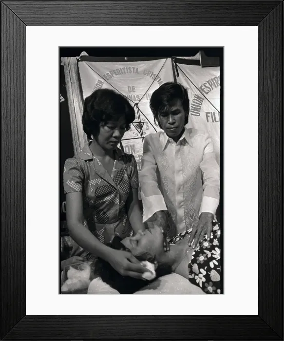 Framed Print : Alex Orbito is Shown Applying Pressure to a Patient's Neck Framed Print : Alex Orbito is Shown Applying Pressure to a Patient's Neck