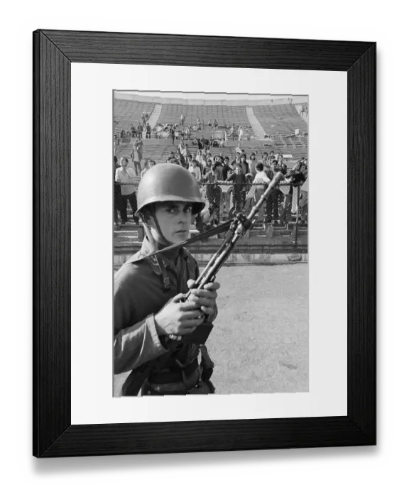 Framed Print : Armed Guard with Prisoners in Stadium
