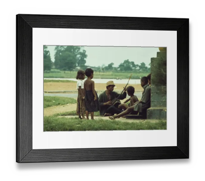 Framed Print : Man Playing Instrument In Phnom Penh