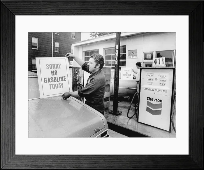 Framed Print : Workers Placing Signs on Gas Pumps Framed Print : Workers Placing Signs on Gas Pumps