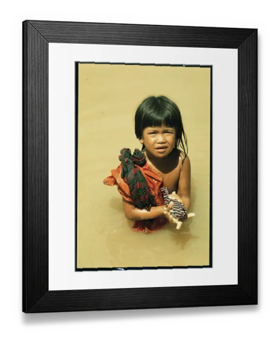 Framed Print : Cambodian Girl Washes Clothing Framed Print : Cambodian Girl Washes Clothing