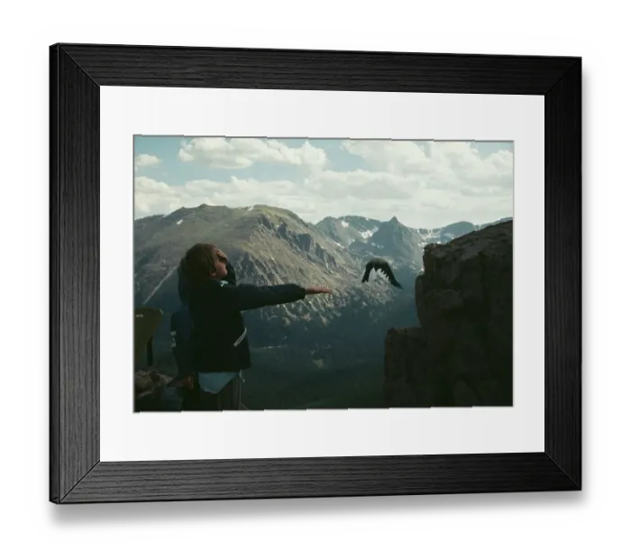 Framed Print : Boy Feeding Bird In Rocky Mountains Framed Print : Boy Feeding Bird In Rocky Mountains