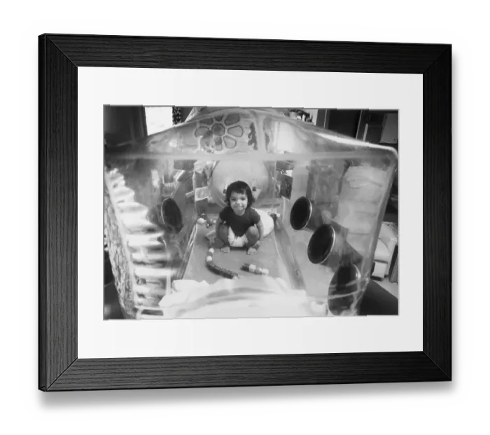 Framed Print : Baby David Plays In His Plastic Bubble