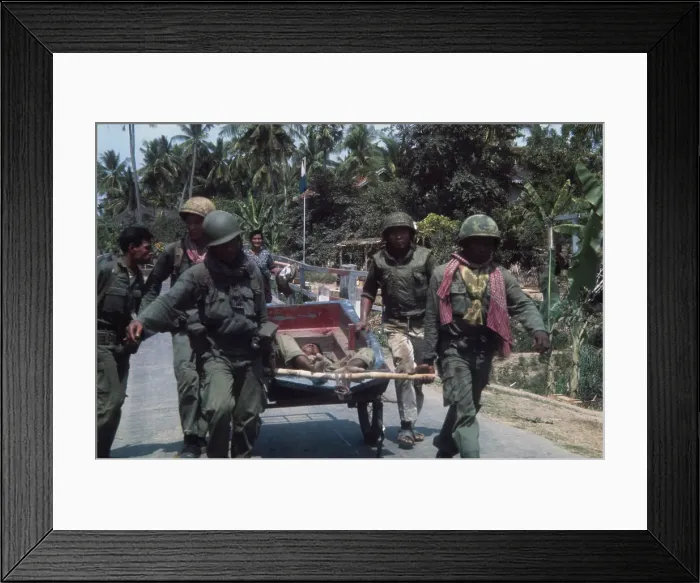Framed Print : Cambodian soldiers haul wounded comrade Framed Print : Cambodian soldiers haul wounded comrade