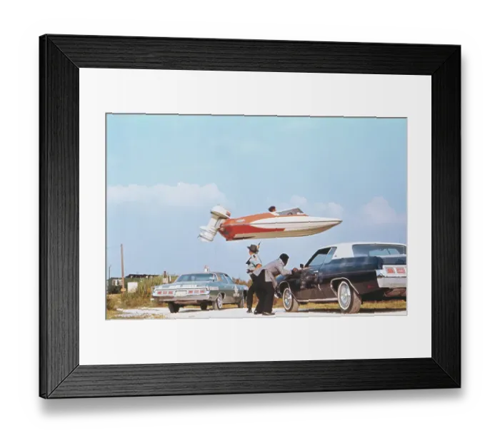 Framed Print : Stuntman Jumping a Speedboat over Cars Framed Print : Stuntman Jumping a Speedboat over Cars