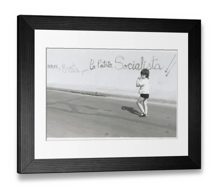Framed Print : Child Walking by Political Graffiti
