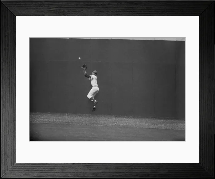 Framed Print : Baseball Player Jumping to Catch Ball Framed Print : Baseball Player Jumping to Catch Ball