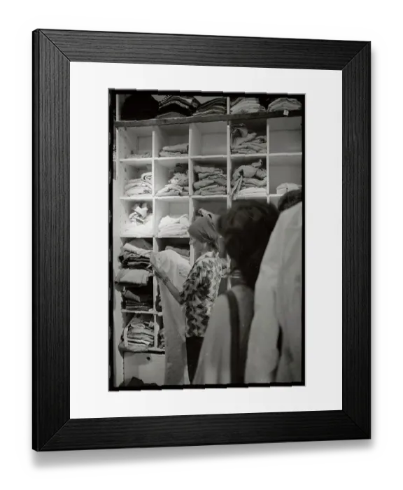 Framed Print : Woman Examining Pants in Store Framed Print : Woman Examining Pants in Store