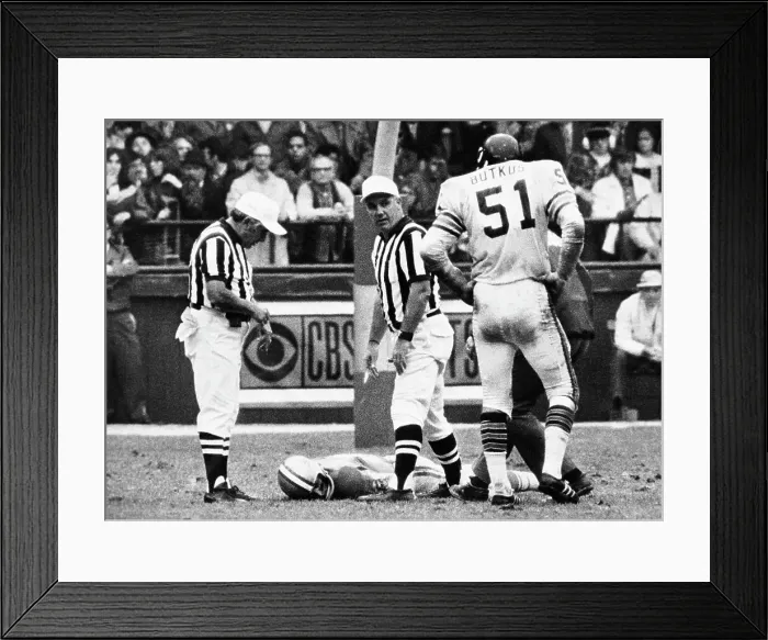 Framed Print : Dick Butkus Watches as Chuck Hughes Lies on Field Framed Print : Dick Butkus Watches as Chuck Hughes Lies on Field