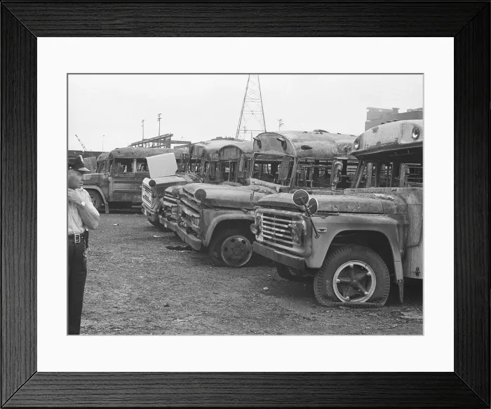 Framed Print : Policeman Examines Burned Buses Framed Print : Policeman Examines Burned Buses