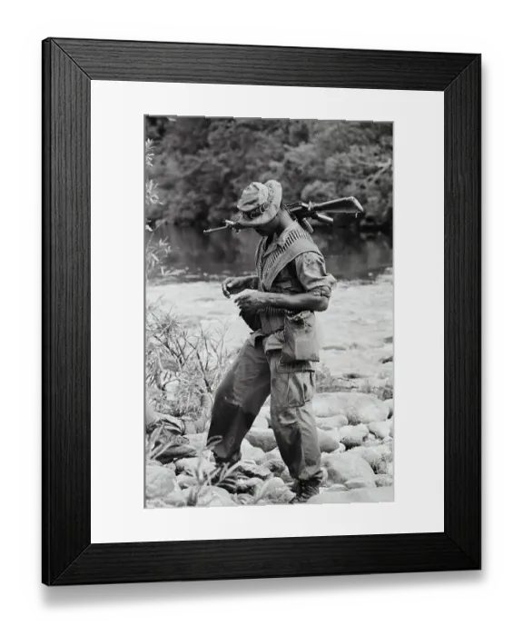 Framed Print : American GI Stepping Across Rocks